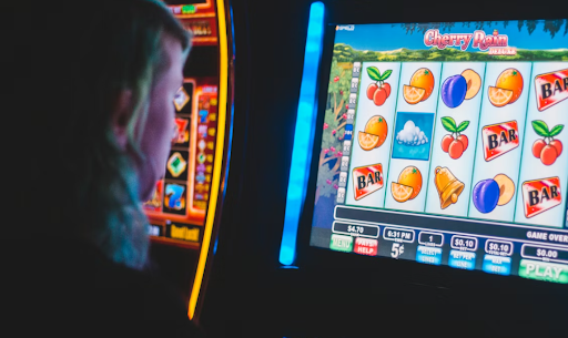 Photo of a person playing a slot machine